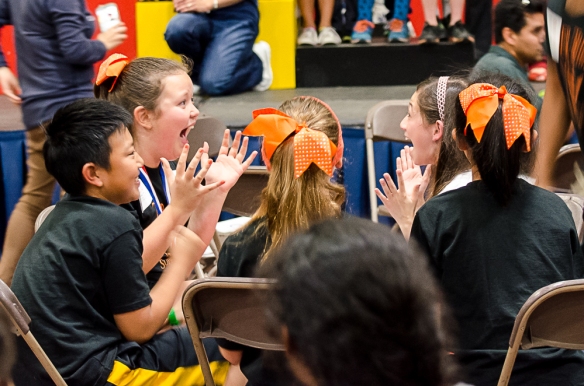 Superquiz team member Jenna C. reacts with LM CAO Champ Hailey J. when they find out they've won the event.